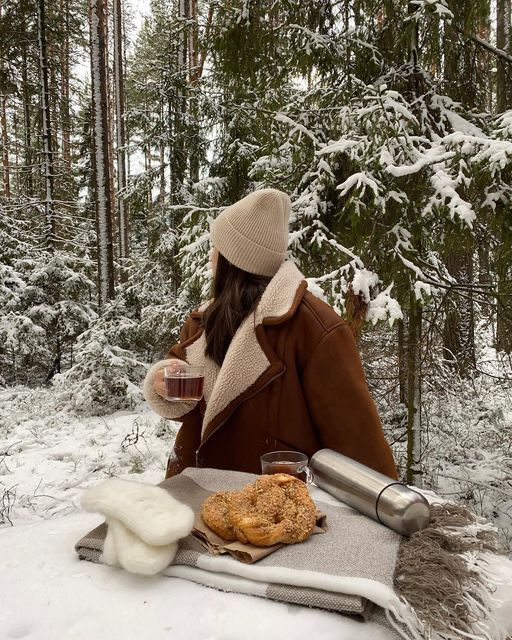 Girl in snow happy wellbeing with warm drink